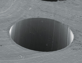 A 200-micron-diameter hole in 0.7-thick-silicon using a picosecond laser with a wavelength of 355 nm.