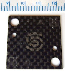 FIGURE 5. Surface texturing and hole drilling in CFRP without any visible fiber damage using the Quasar UV laser. FIGURE 5. Surface texturing and hole drilling in CFRP without any visible fiber damage using the Quasar UV laser.