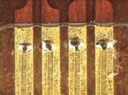 FIGURE 7. A 0.008-in thick copper flat wire welded to a 0.008-in thick copper lead frame coated. FIGURE 7. A 0.008-in thick copper flat wire welded to a 0.008-in thick copper lead frame coated.