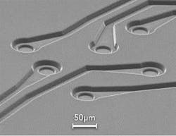 FIGURE 2. Excimer laser ablation produces clean, small features in polyimide. FIGURE 2. Excimer laser ablation produces clean, small features in polyimide.