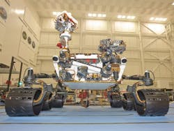 The MSL rover, Curiosity, is shown inside the Spacecraft Assembly Facility at the Jet Propulsion Laboratory (Pasadena, CA). The ChemCam is at the top of the mast just left of center.