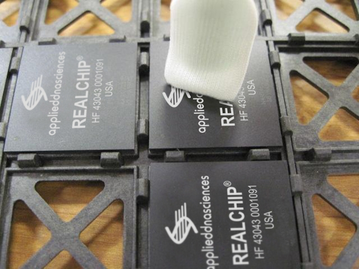 DNA on a microchip is captured by a swab and then sent for lab analysis to verify chip identity and prevent counterfeiting
