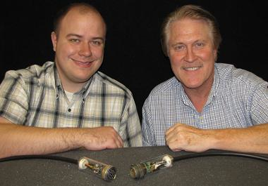 Titus Appel, left, and Steve Sanderson of Sandia National Laboratories display a first-generation power-over-fiber cable.