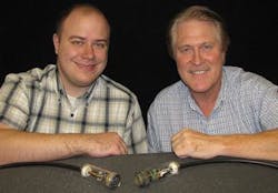 Titus Appel, left, and Steve Sanderson of Sandia National Laboratories display a first-generation power-over-fiber cable. Titus Appel, left, and Steve Sanderson of Sandia National Laboratories display a first-generation power-over-fiber cable.