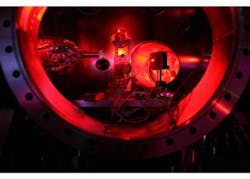 A photograph shows the interior of the Linac Coherent Light Source (LCLS) experimental chamber, set up for an investigation to create and measure a form of extreme, two-million-degree matter. The central part of the frame contains the material that will be converted to the hot, dense matter. To the left is an XUV spectrometer and to the right is a small red laser set up for alignment and positioning. A photograph shows the interior of the Linac Coherent Light Source (LCLS) experimental chamber, set up for an investigation to create and measure a form of extreme, two-million-degree matter. The central part of the frame contains the material that will be converted to the hot, dense matter. To the left is an XUV spectrometer and to the right is a small red laser set up for alignment and positioning.