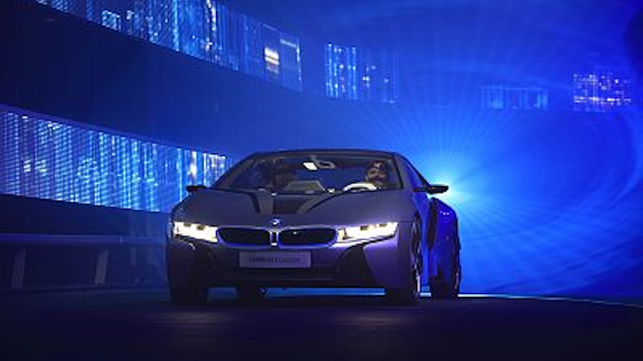 Blue laser light forms a “birthing tunnel” that highlights a BMW high-efficiency “i” series car