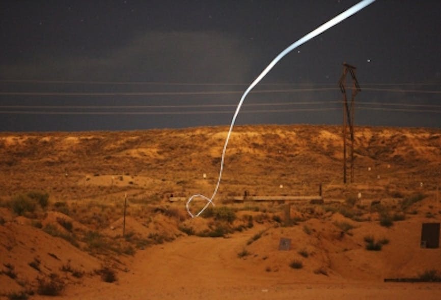 A nighttime test of the Sandia self-guided bullet with an LED attached highlights its path.