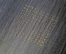 Small gold spots are laser-clad onto stainless steel. Small gold spots are laser-clad onto stainless steel.