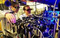 Georgia Tech graduate student Yaroslav Dudin and professor Alex Kuzmich (l-r) adjust optics as part of research into the production of single photons for use in optical quantum information processing and the study of certain physical systems. Georgia Tech graduate student Yaroslav Dudin and professor Alex Kuzmich (l-r) adjust optics as part of research into the production of single photons for use in optical quantum information processing and the study of certain physical systems.