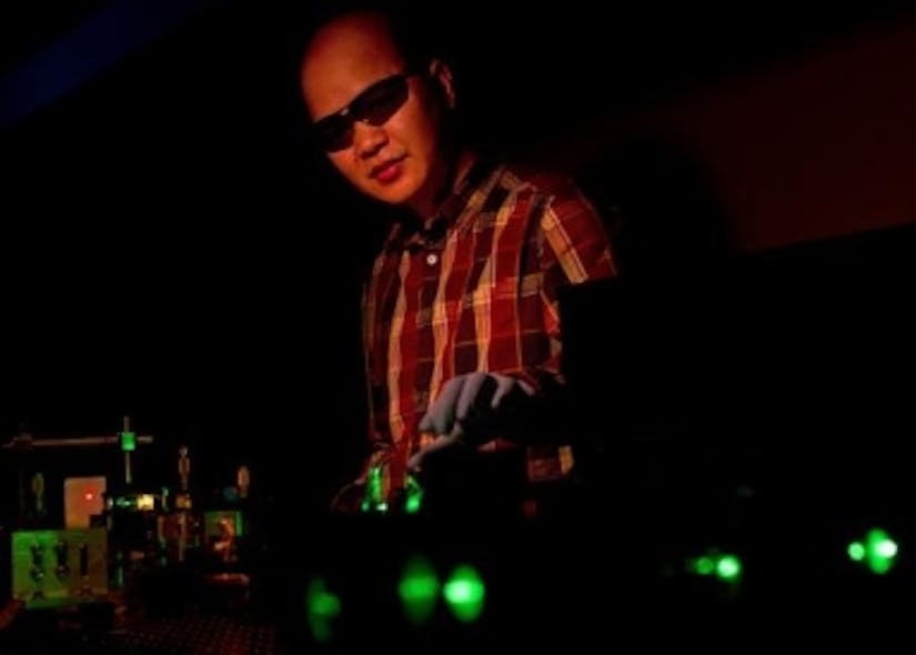 Cuong Dang of Brown University manipulates a green laser beam that pumps quantum dots, in this case producing red laser light.