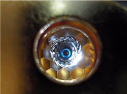 A view of a cryogenically cooled NIF target as 'seen' by the laser through the hohlraum's laser entrance hole. In ignition experiments, the hydrogen in the fuel capsule must be compressed to about 100 times the density of lead. A view of a cryogenically cooled NIF target as 'seen' by the laser through the hohlraum's laser entrance hole. In ignition experiments, the hydrogen in the fuel capsule must be compressed to about 100 times the density of lead.
