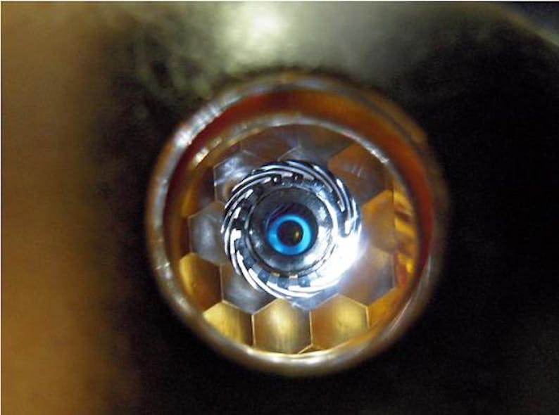 A view of a cryogenically cooled NIF target as &apos;seen&apos; by the laser through the hohlraum&apos;s laser entrance hole. In ignition experiments, the hydrogen in the fuel capsule must be compressed to about 100 times the density of lead.