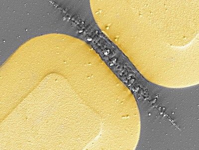 A scanning-electron micrograph shows damaged vanadium dioxide in the gap of a terahertz metamaterial made of gold. The damage results when strong field enhancement of incident terahertz radiation in the gaps leads to a rapid increase in the energy density following the field-driven insulator-to-metal transition.