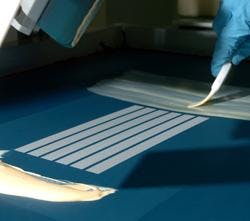 Dyesol employee, Bernard Jausnik, operates the screen printer. Dyesol employee, Bernard Jausnik, operates the screen printer.