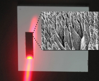 Black silicon is irradiated with a laser. Small image: Black silicon, magnified.