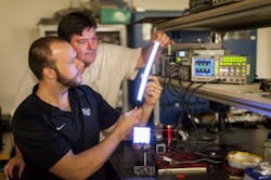 Wake Forest University physics professor David Carroll works with graduate student Greg Smith on FIPEL lighting technology.