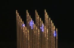 An optical image of the 3D array for optogenetics research shows individual light ports illuminated; the array looks like a series of fine-toothed combs laid next to each other with their teeth pointing in the same direction. An optical image of the 3D array for optogenetics research shows individual light ports illuminated; the array looks like a series of fine-toothed combs laid next to each other with their teeth pointing in the same direction.