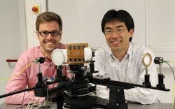 Yasuaki Monnai (right) and Kristian Altmann have created a terahertz beam-steering and focusing device, shown mounted to the characterization setup at Marburg University. Yasuaki Monnai (right) and Kristian Altmann have created a terahertz beam-steering and focusing device, shown mounted to the characterization setup at Marburg University.