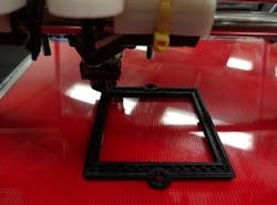 An open-source 3D printer prints an optical component, in this case a filter bracket. An open-source 3D printer prints an optical component, in this case a filter bracket.