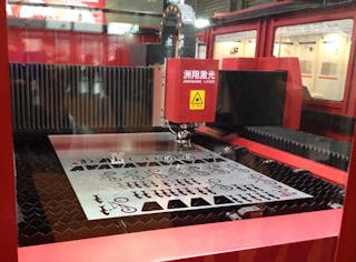Exhibits at the 2013 Laser World of Photonics conference in Shanghai were big and full of photonics equipment, such as this laser cutting system from Wuxi Zhouxiang Laser Machinery.