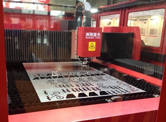 Exhibits at the 2013 Laser World of Photonics conference in Shanghai were big and full of photonics equipment, such as this laser cutting system from Wuxi Zhouxiang Laser Machinery.