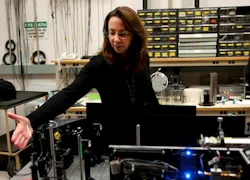 NAWCAD engineer Linda Mullen demonstrates a laser used in underwater optics. Mullen patented a new encoding method for laser imaging, which offers possibilities for both fleet and commercial use.