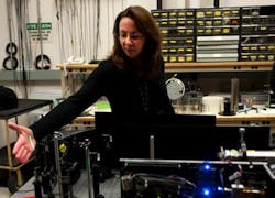 NAWCAD engineer Linda Mullen demonstrates a laser used in underwater optics. Mullen patented a new encoding method for laser imaging, which offers possibilities for both fleet and commercial use.