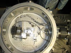 In the vacuum chamber in which the acceleration occurs, the petawatt laser beam arrives from the right. The gas cell is in the center of the chamber. The actual acceleration occurs over a distance of about an inch within the gas cell.