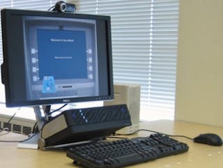 Researchers developed this prototype to test eye-tracking authentication. The monitor shows a welcome screen; the eye tracker is positioned below the screen.