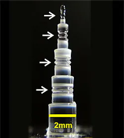 This photo shows four NIST-created glass resonators with diameters (top to bottom) of 0.36, 0.71, 1.2, and 1.5 mm. Smaller cavities produce frequency combs with wider spacing between the comb teeth.