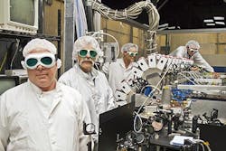 The Boeing Thin Disk Laser system, which integrates a series of high-power industrial lasers to generate one concentrated, high-energy beam, exceeded required thresholds for power and beam quality during a demonstration for the Department of Defense&apos;s Robust Electric Laser Initiative (RELI) effort. In this photo, Boeing Thin Disk Laser engineers work with the system&apos;s main optical bench.