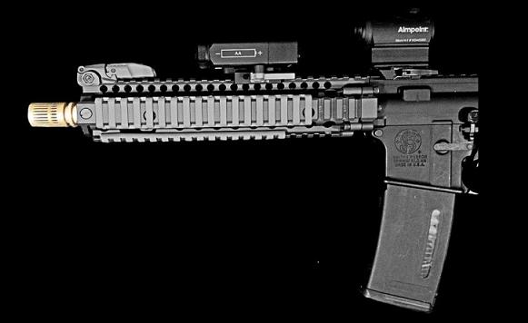 An AR-15 pistol is equipped with an Auxetic muzzle break fabricated using a 3D printing process. (Image credit: Sintercore)