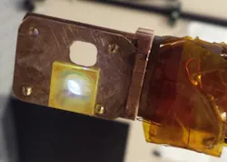 A yellowish platinum-rich polymer known as Pt-1 emits light as a laser beam hits it. The light appears white because the polymer emits a combination of broad-spectrum violet and yellow, which combine to appear white.