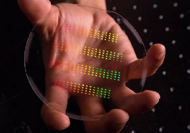 The nanoscale patterns of SLAC and Stanford's accelerator on a chip gleam in rainbow colors prior to being assembled and cut into their final forms.