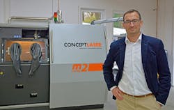 Concept Laser head of development Florian Bechmann is shown with a LaserCUSING system, and says, &apos;Safety aspects, automation and effective QA measures are paramount for us.&apos; (Image credit: Concept Laser)