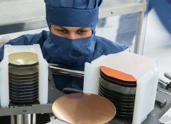 A view in the clean room shows an assembly system transporting a 6-in. wafer; 4-in. wafers can be seen on the left.