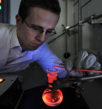 Micha&lstrok; Maciejczyk, a doctoral student at the IPC PAS, demonstrates the record efficient luminescence of a europium complex with phosphine oxide co-ligands.
