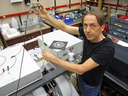 University of Utah physicist Christoph Boehme works in his laboratory on an apparatus used in a new study that brings physics a step closer to &ldquo;spintronic&rdquo; devices such as superfast computers, more compact data storage devices and more efficient organic LEDs or OLEDS than those used today for display screens in cell phones, computers and televisions.