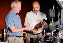 Georgia Tech researchers Ken Sandhage, left, and Ali Adibi examine a porous-silicon optical sensing device and a silicon wafer.