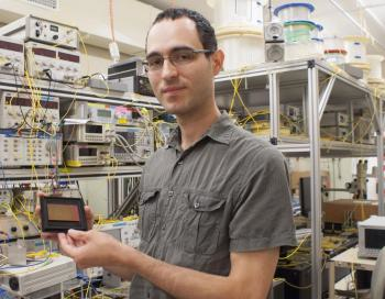 Simon Lefrancois from the University of Sydney's School of Physics holds a chalcogenide optical chip used in the terabit oscilloscope.