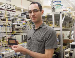 Simon Lefrancois from the University of Sydney's School of Physics holds a chalcogenide optical chip used in the terabit oscilloscope.