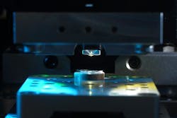 A near-field microscope is shown analyzing a fragment of a GaN wafer. A near-field microscope is shown analyzing a fragment of a GaN wafer.