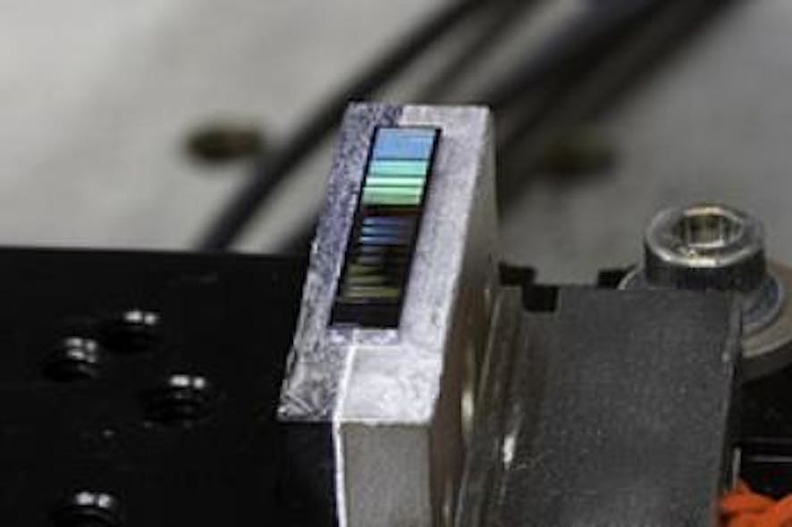 A silicon photonic chip is placed on a temperature-controlled stage; optical fibers (not shown) are used to couple an optical pump beam to the chip at one of the cleaved facets (left side of the chip), and to extract the generated photon pair from the cleaved facet at the right side of the chip.