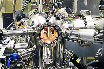 An Ames Laboratory physicist uses angle-resolved photoemission spectroscopy (ARPES) in which light energy (photons) is directed at a sample being studied, photons cause electrons in the sample to be emitted into a vacuum, and an electron analyzer measures the energy and momentum of these electrons to reveal details about the electron properties within the material.