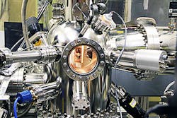 An Ames Laboratory physicist uses angle-resolved photoemission spectroscopy (ARPES) in which light energy (photons) is directed at a sample being studied, photons cause electrons in the sample to be emitted into a vacuum, and an electron analyzer measures the energy and momentum of these electrons to reveal details about the electron properties within the material. An Ames Laboratory physicist uses angle-resolved photoemission spectroscopy (ARPES) in which light energy (photons) is directed at a sample being studied, photons cause electrons in the sample to be emitted into a vacuum, and an electron analyzer measures the energy and momentum of these electrons to reveal details about the electron properties within the material.