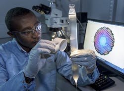 Eric Numkam-Fokoua of the University of Southampton inspects a hollow-core optical fiber preform. Eric Numkam-Fokoua of the University of Southampton inspects a hollow-core optical fiber preform.