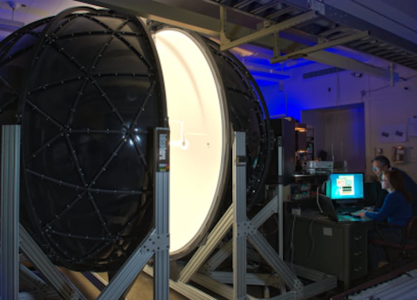 Ben Tsai and Maria Nadal of NIST use a large integrating sphere for measurements on LED solid-state lighting (SSL) devices.