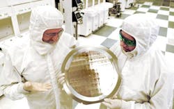 Michael Liehr (left) of SUNY Polytechnic Institute's Colleges of Nanoscale Science and Engineering and Bala Haran (right) of IBM Research inspect a wafer containing 7-nm-node test chips in a clean room in Albany, NY. IBM Research, working with alliance partners at SUNY Poly CNSE, has produced the semiconductor industry's first 7-nm-node test chips with functional transistors. Michael Liehr (left) of SUNY Polytechnic Institute's Colleges of Nanoscale Science and Engineering and Bala Haran (right) of IBM Research inspect a wafer containing 7-nm-node test chips in a clean room in Albany, NY. IBM Research, working with alliance partners at SUNY Poly CNSE, has produced the semiconductor industry's first 7-nm-node test chips with functional transistors.