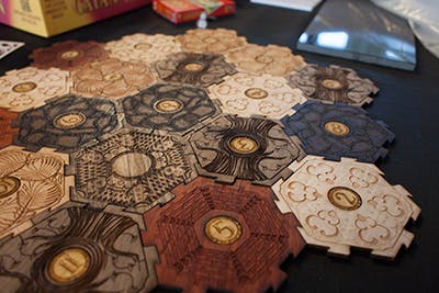 An example of Glowforge laser-printed components: in this case, laser cut and engraved board game pieces.