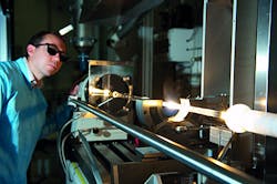 Production of an optical fiber on a silica lathe. Production of an optical fiber on a silica lathe.